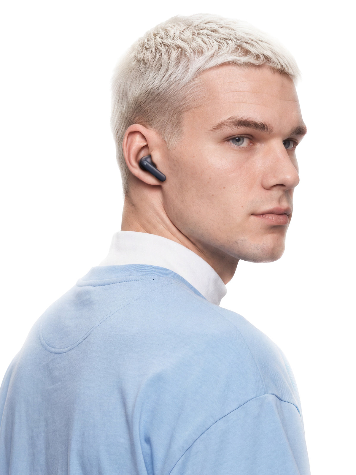 A listener wearing CMF Buds Neo and looking over his shoulder