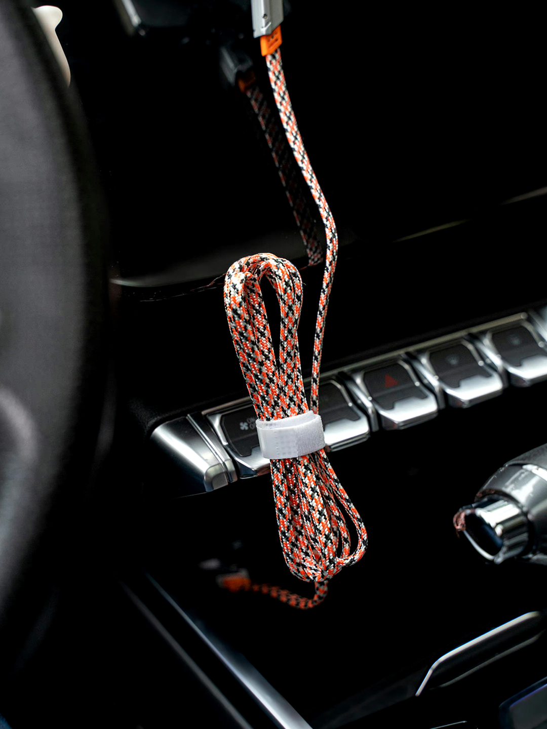 Orange ONIX cable coiled beside a car centre console.