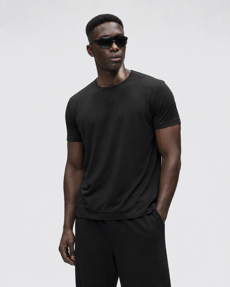 Front view of the Black Relaxed Tee with black trousers.