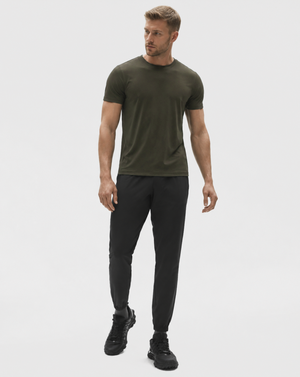 Full-length studio view of the Pine Relaxed Tee with black trousers.