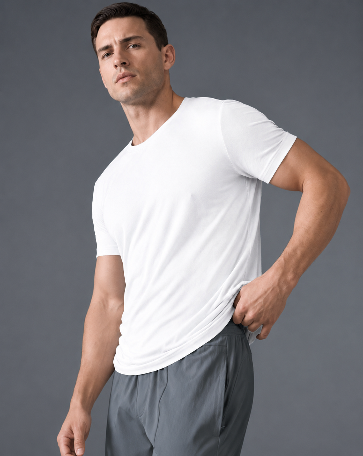 Three-quarter view of the White Relaxed Tee, with one hand resting at the waist.