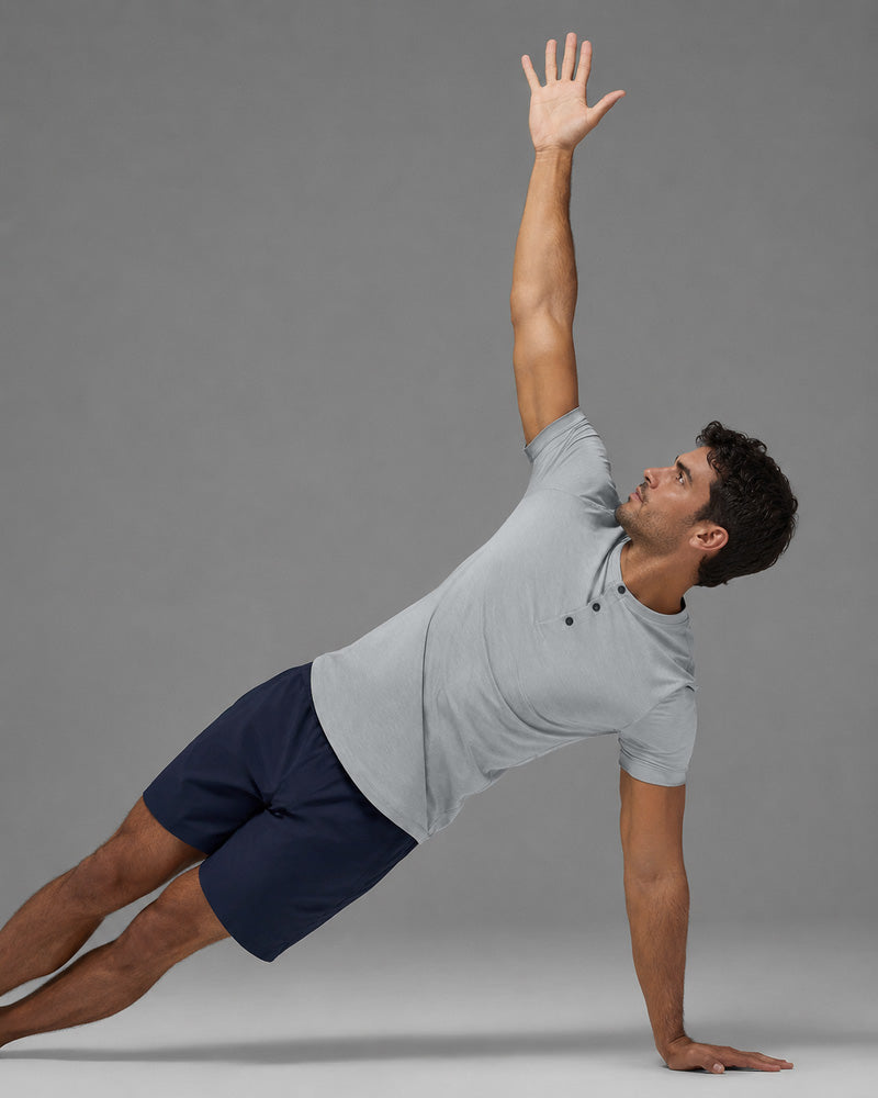 Model holding a side plank in the Overcast light grey Henley.