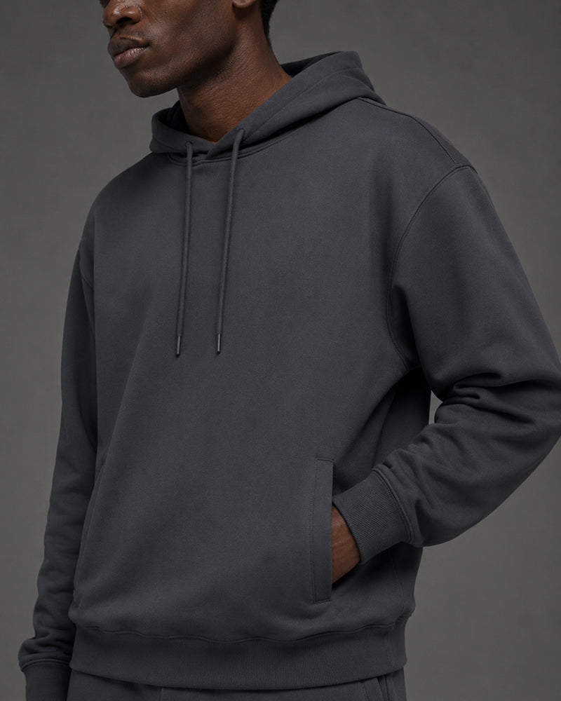 TexTale hoodie in Charcoal with a hand in the front pocket