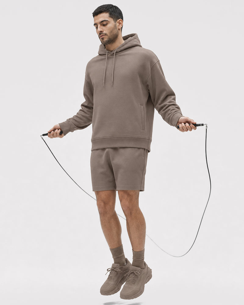 Model wearing TexTale hoodie in Dune while skipping rope