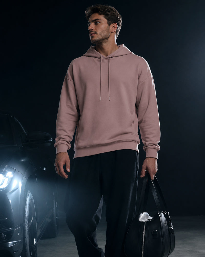 Model beside a car wearing the TexTale Rain-Repel Hoodie in Pink Gray